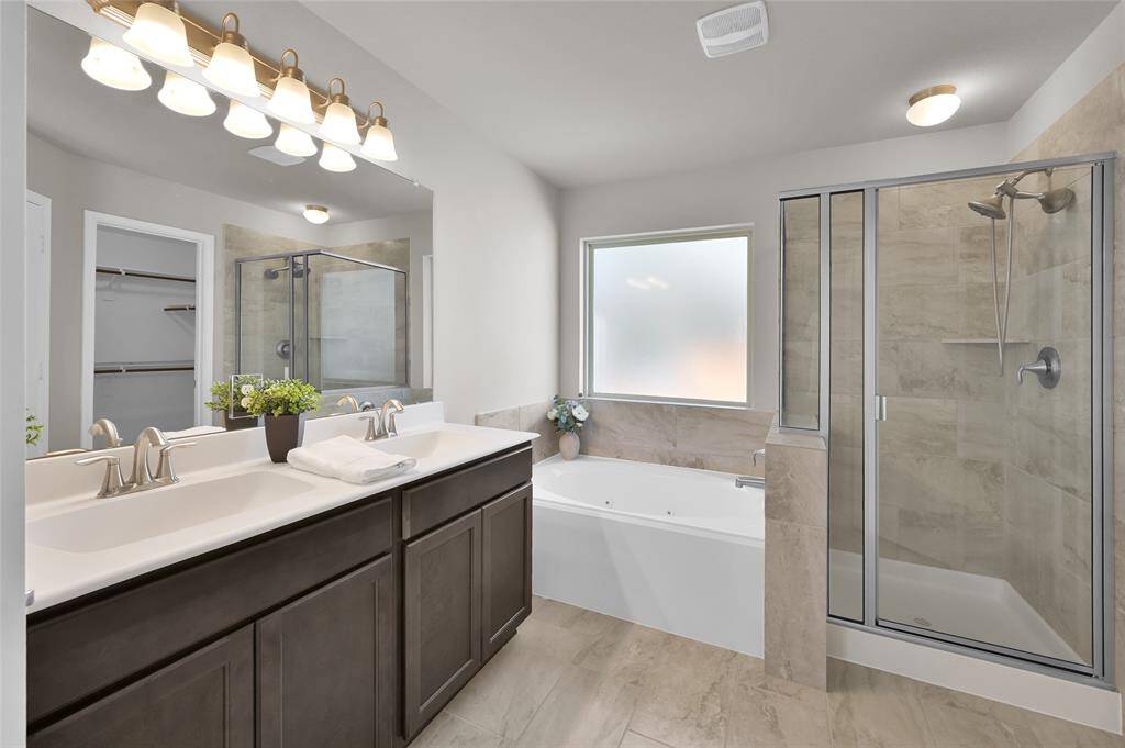 Double sinks, garden tub and separate shower in primary bath.