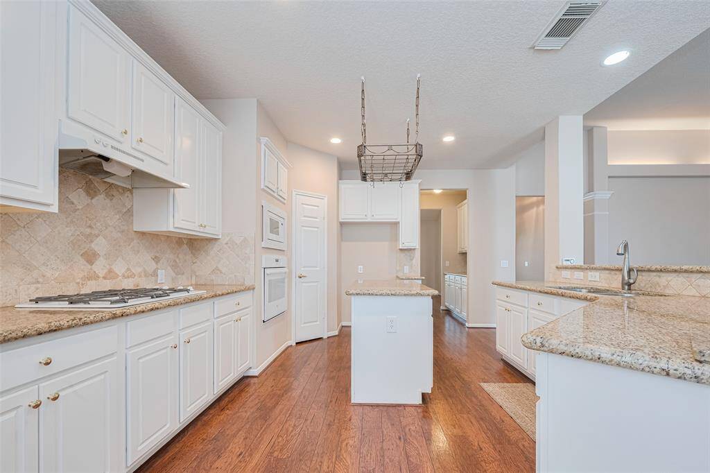 This gorgeous kitchen is the heart of this home.  Boasting granite countertops, an abundance of cabinet space, a very large walk-in pantry and island with pot rack.