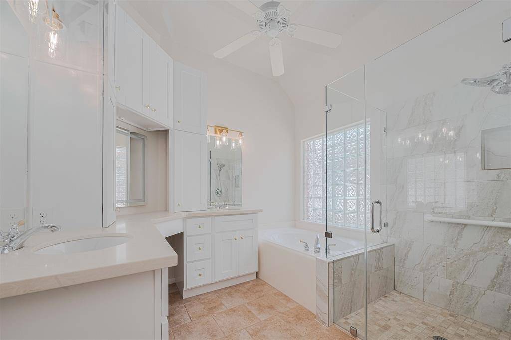 Pure elegance and serenity in this amazing bathroom boasting a large walk-in shower with seamless glass doors, quartz countertops & ceramic tile.  There is also a built-in vanity light-up mirror!