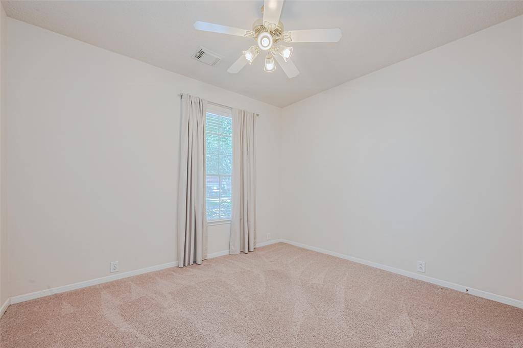 Bedroom #3 features fresh paint, a ceiling fan and lush carpet.