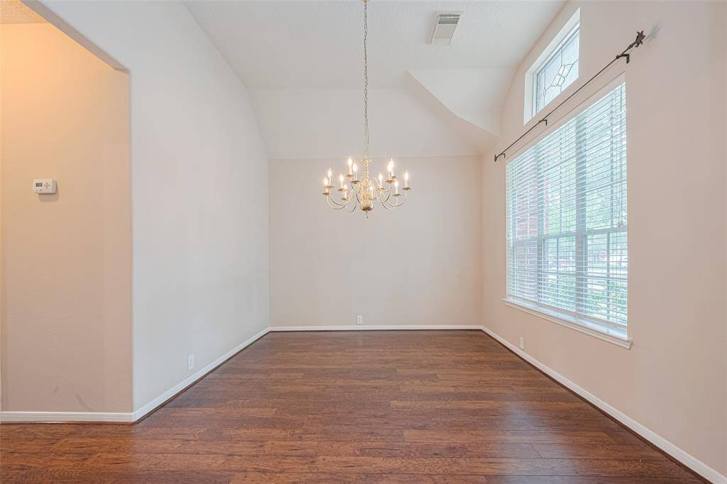 The formal dining room is large, features high ceilings, an elegant stain glass accent window.