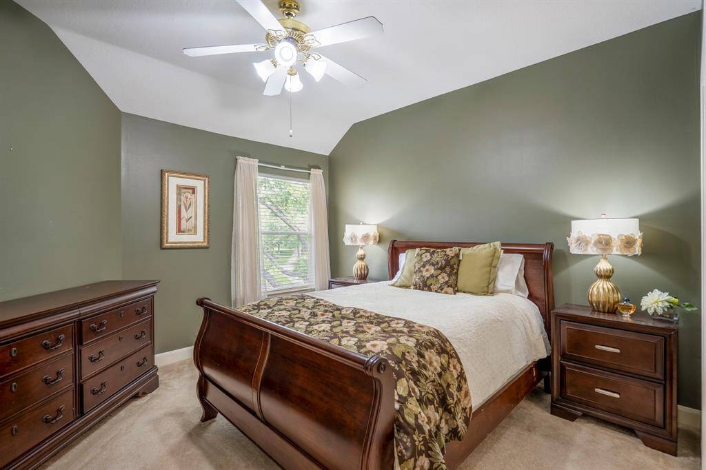 Generous bedroom used as a craft room, offering ample space, natural light from windows, plush carpeting, and a closet for extra storage.