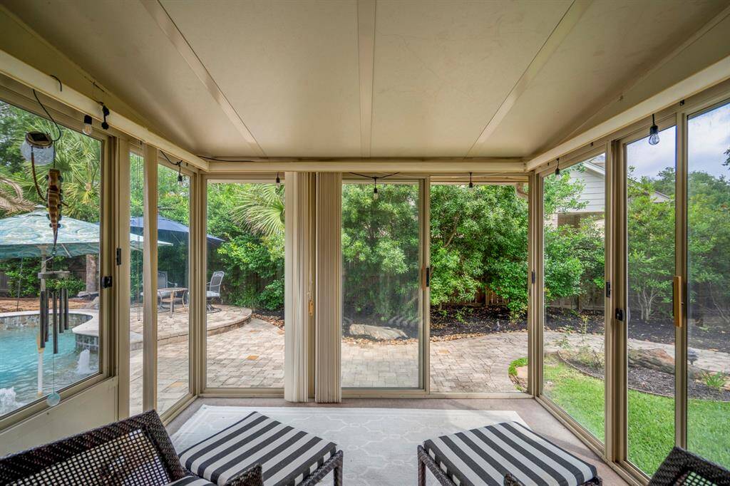 Bright sunroom overlooking the patio and pool area. Perfect for relaxation and entertaining.