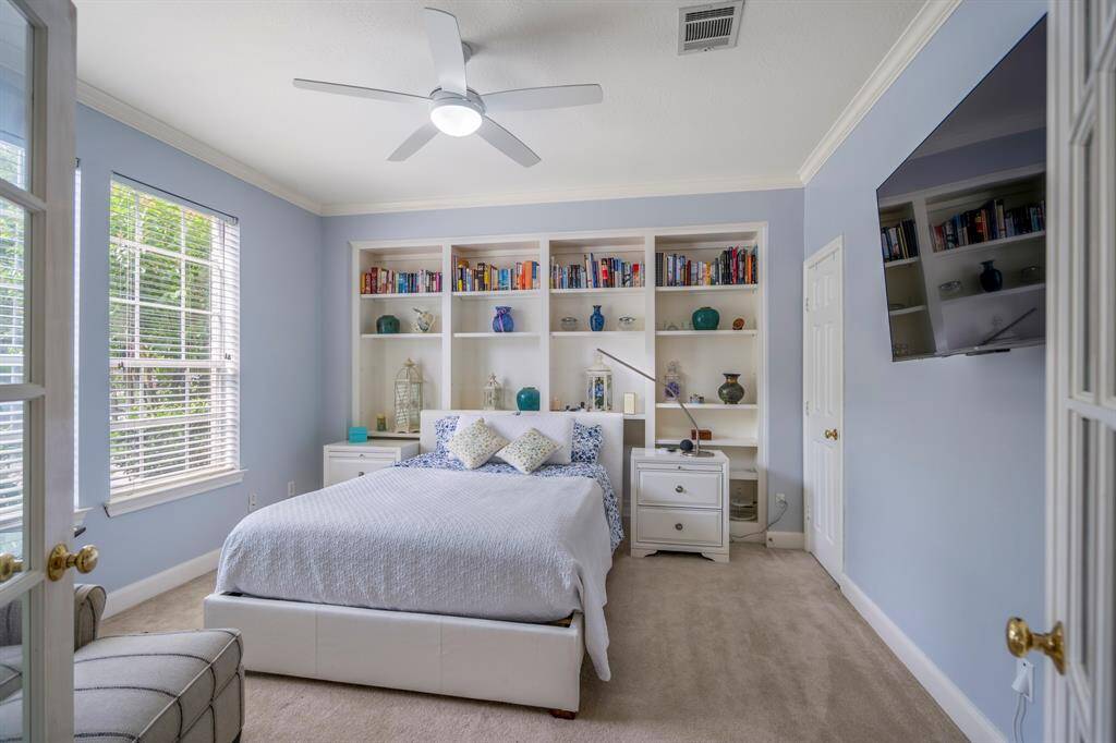 Inviting entryway with crown molding, featuring a dining room on one side and a versatile room on the other.