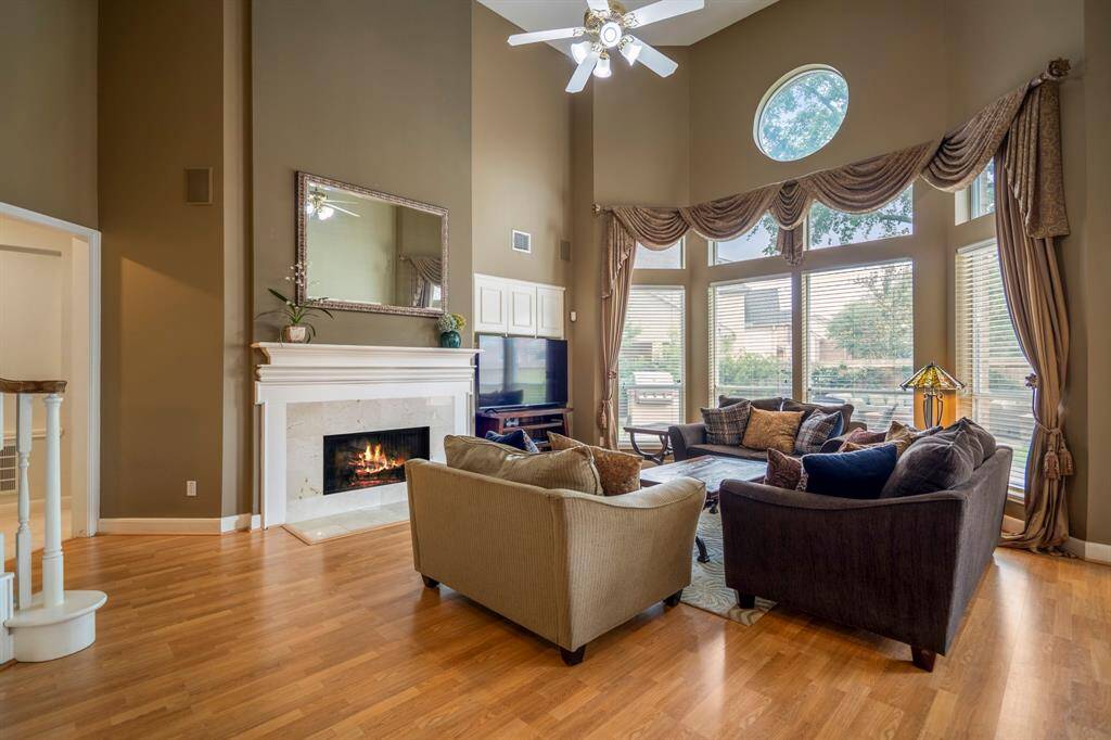 Cozy bedroom with plush carpeting, abundant natural light streaming through windows, and built-in bookshelves for added charm and storage.