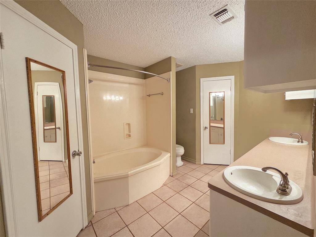 Primary Bath with Double Sinks, His and Her Walk-In Closets.