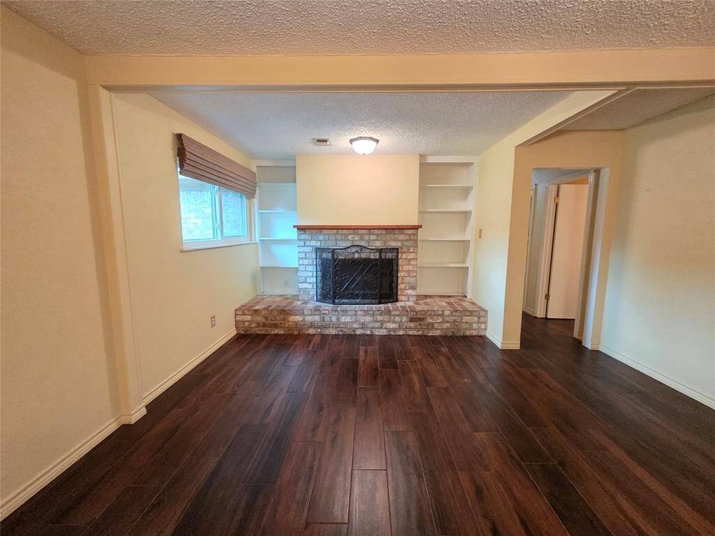 Living Room with a Wood Burning Fireplace made out of Iron Ore which will keep this home warm in the Winter! Built in Shelves also!!