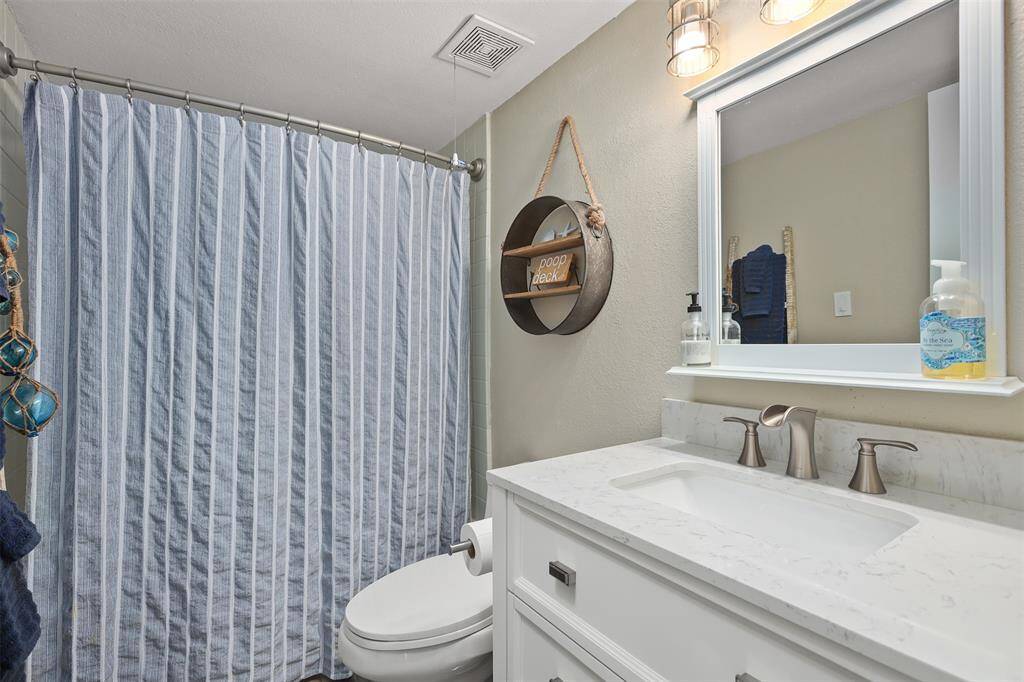 Guest bathroom has a tub.