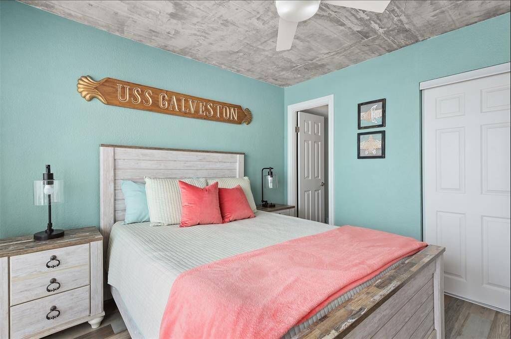 Primary bedroom has balcony access and an ensuite bath. The plaque above the bed is excluded and will be replaced.