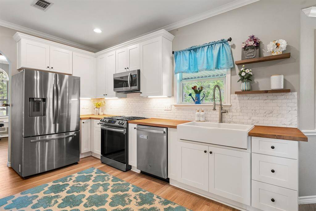 Kitchen upgrades include SS appliances, farmhouse sink and butcher block countertops.
