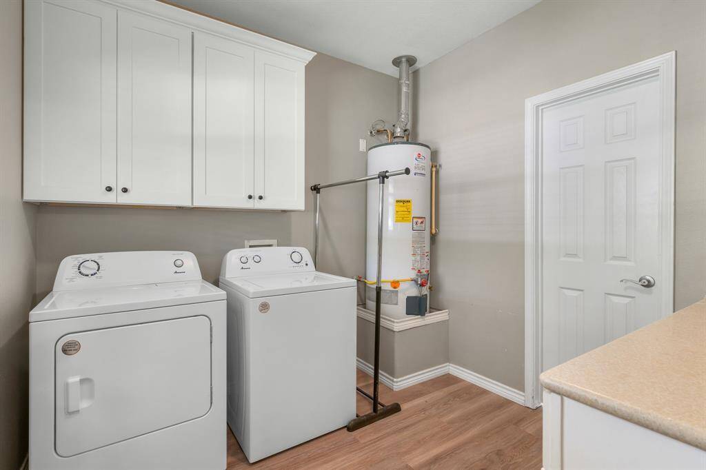 Plenty of space in the utility rom with extra cabinets and counter space.