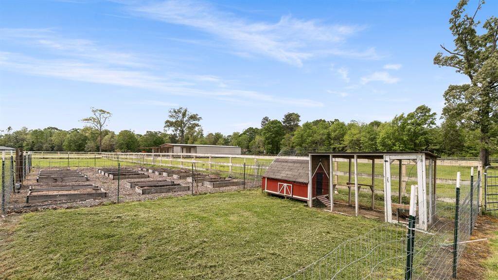 22 raised garden beds all w/ their own irrigation system and separate area w/ coup for the egg laying chickens.