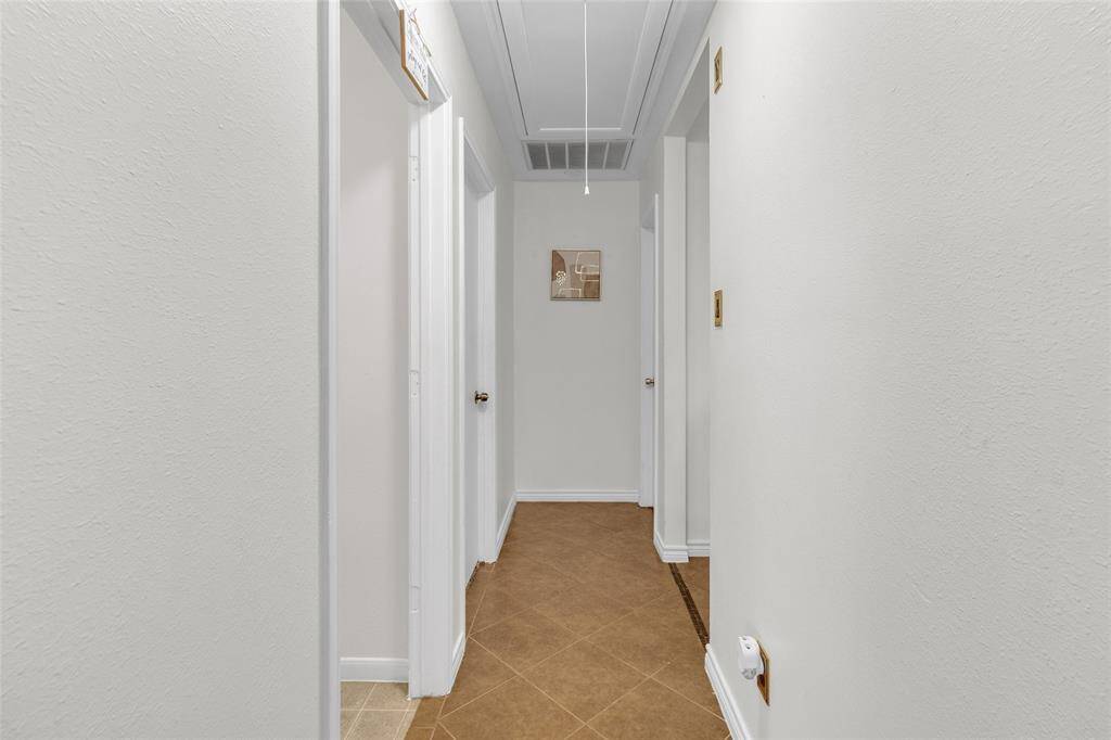 Inviting corridor leading to private bedrooms and convenient laundry facilities.