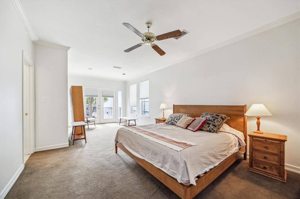Expansive primary bedroom with a cozy sitting area, luxurious en-suite, and balcony overlooking the pool.