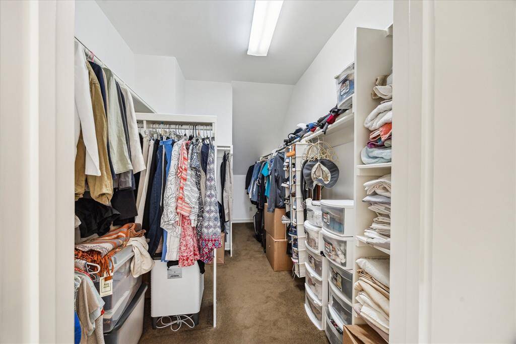 Spacious walk-in closet enhances the primary bedroom.