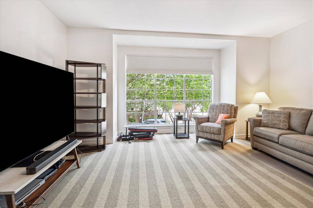 Expansive second-floor bedroom with street views.