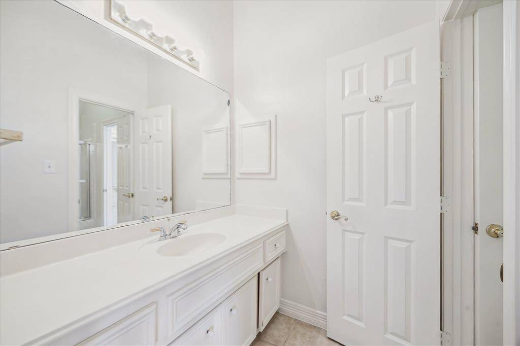 Spacious full bathroom with ample cabinetry.