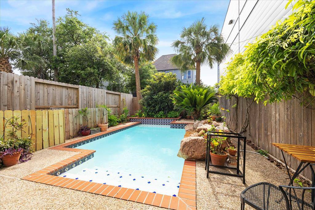 A stunning backyard oasis featuring a sparkling pool, perfect for relaxation and entertaining.