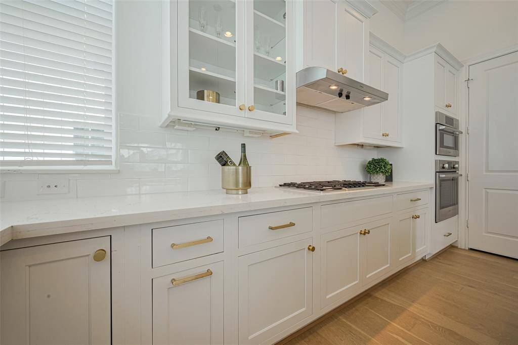 The oven with microwave above it is located at the end of this wall of cabinetry. Notice that the windows even curve around and continue on this wall for a bit.