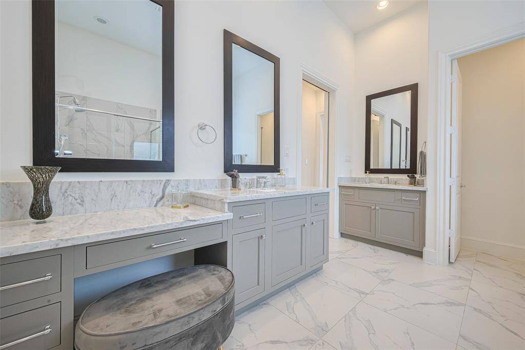 And the beautiful primary bathroom is equally large and stylish, starting with these two sink areas, plus a vanity/makeup area.