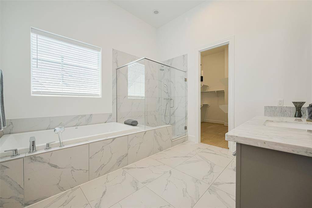 Plenty of room for two to get ready in the AM! Primary closet shown in background.
