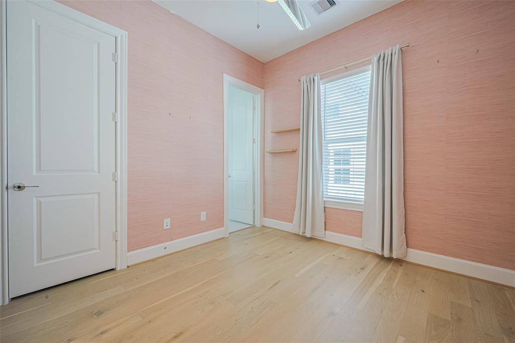 The second bedroom, just down the hall from the primary bedroom suite.
