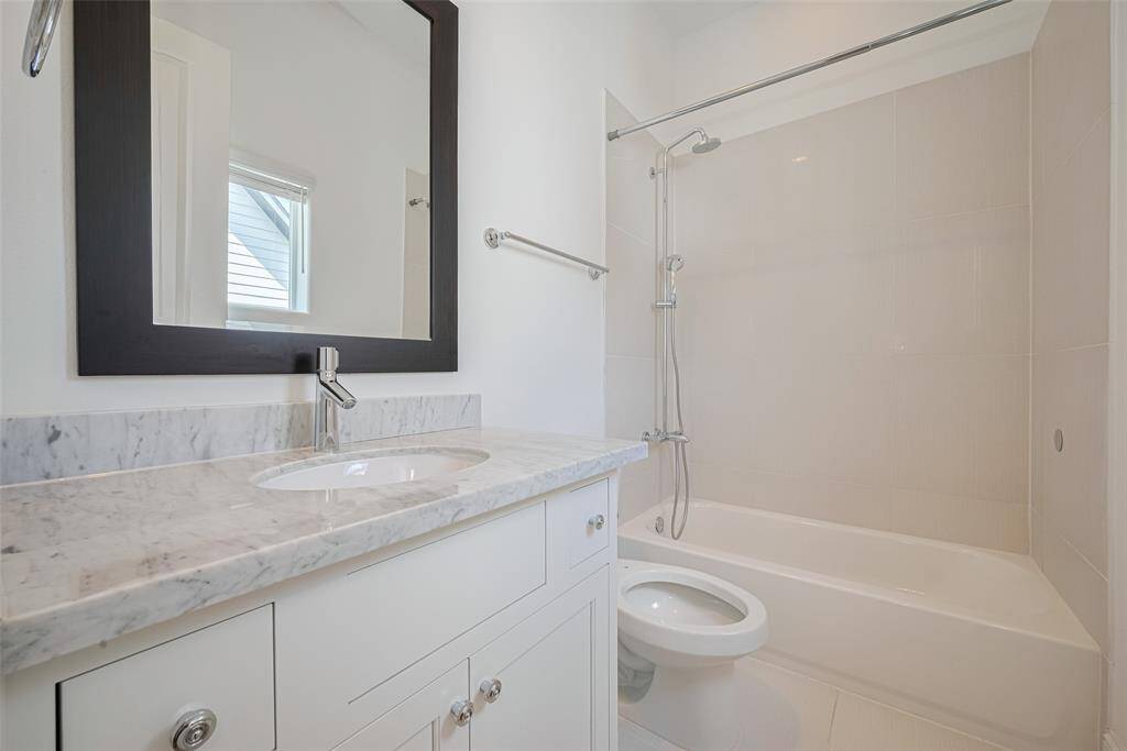 Bathroom is nicely finished with marble countertop.