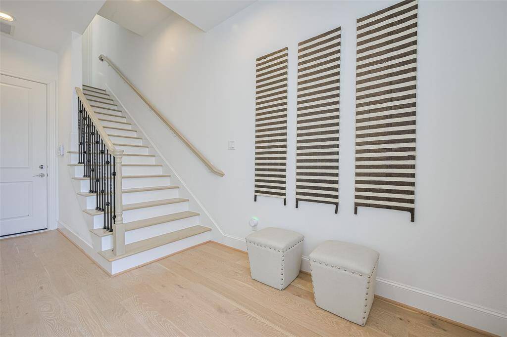 The front door entry area is bright and spacious. Door in the background leads into the garage.