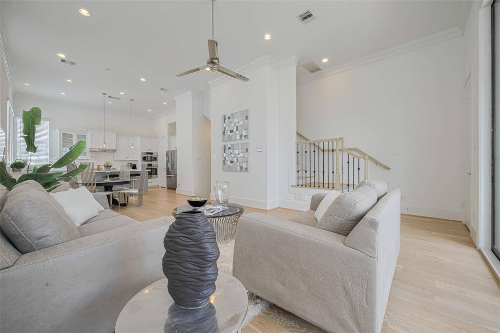 Standing at the back corner near the balcony, this photo shows off the size and openness of the living/dining/kitchen areas.