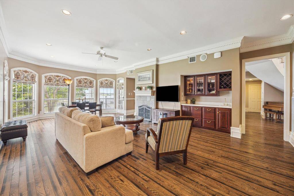 Cozy den with gas log fireplace, wet bar with built ins, and more beautiful hardwoods.