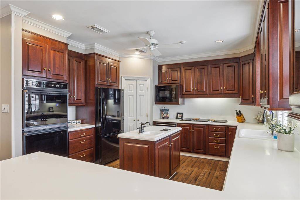This kitchen offers a double oven, 4 burner cooktop with a griddle and a grill, plus a warming drawer, a veggie sink, and a corner pantry!   Plus a counter height breakfast bar!