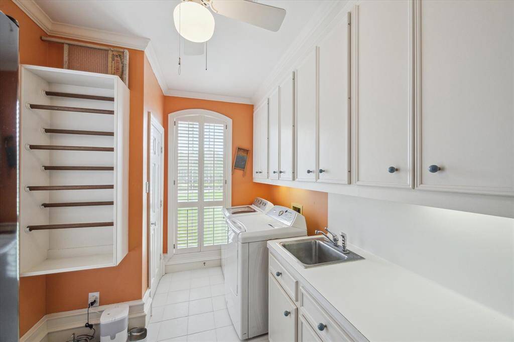Bright and cheerful laundry room conveniently located on main floor with refrigerator, utility closet, and plenty of cabinets.  W/D included.