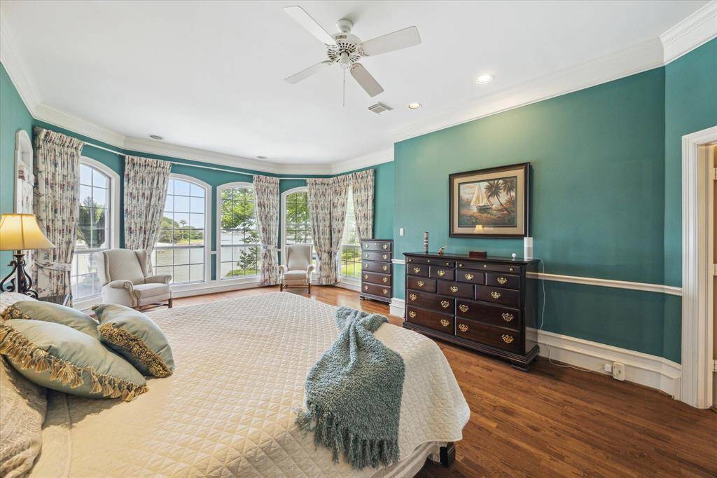 How would you like to wake up to the sunrises these windows produce?  This huge primary bedroom is perfectly situated to wake up with the sun!  Direct access to the back balcony to relax with the birds and your morning coffee.