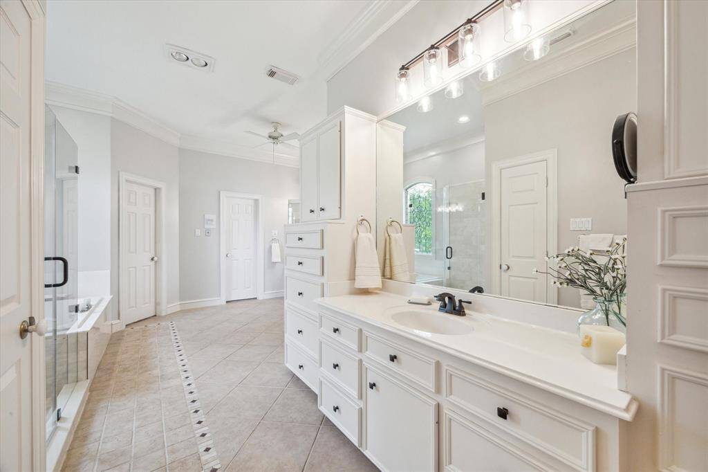 Two large walk in closets with cedar ceilings, and a linen closet complete this primary ensuite.