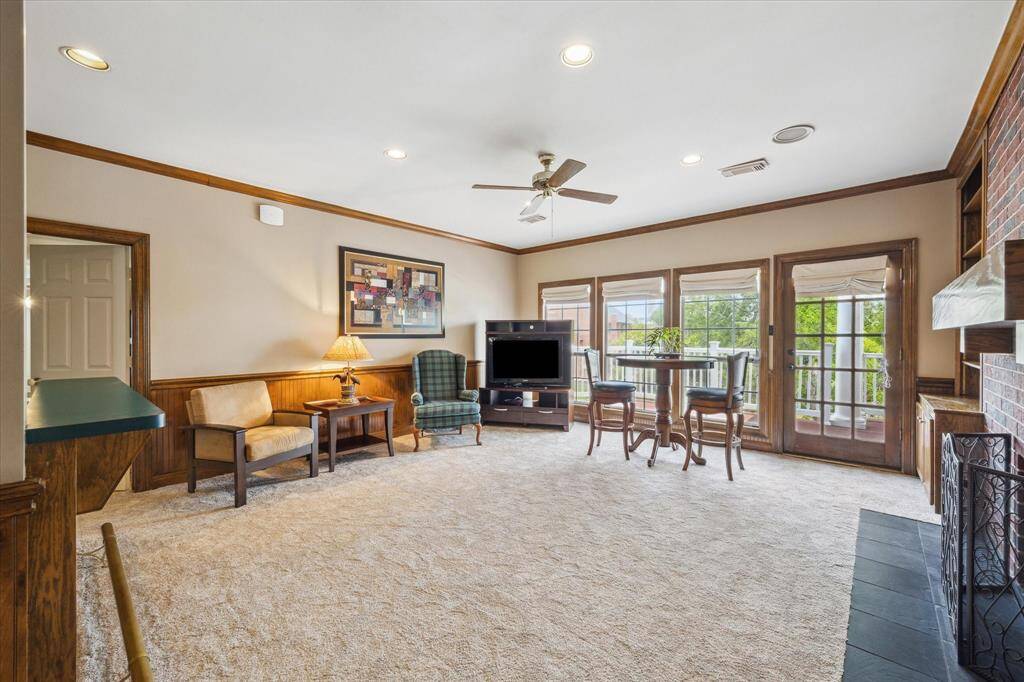 Huge gameroom upstairs with gas log fireplace, large wetbar and direct access to top floor balcony.