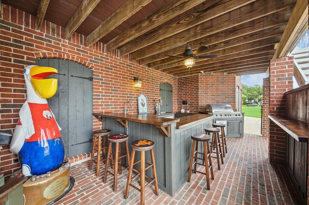 Outdoor kitchen complete with full size sink, refrigerator, Blaze premium 32" natural gas grill with double side burners, and triple tap kegerator!