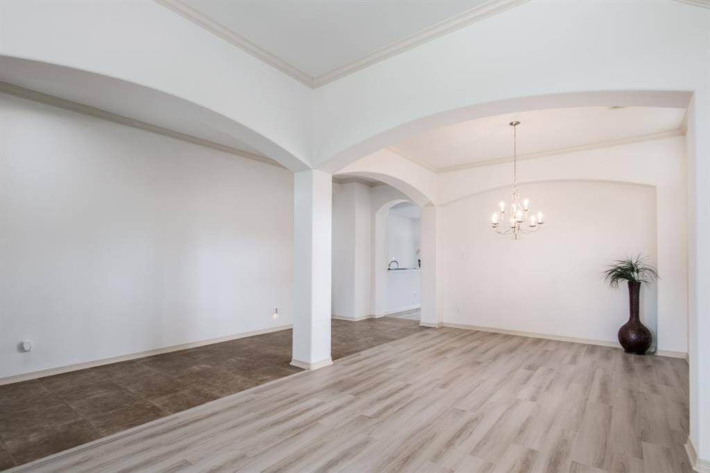 Elegant and inviting, the formal living and dining rooms offer a refined space for entertaining. With large windows, and a seamless flow between the two areas, these rooms combine classic charm with a comfortable atmosphere.