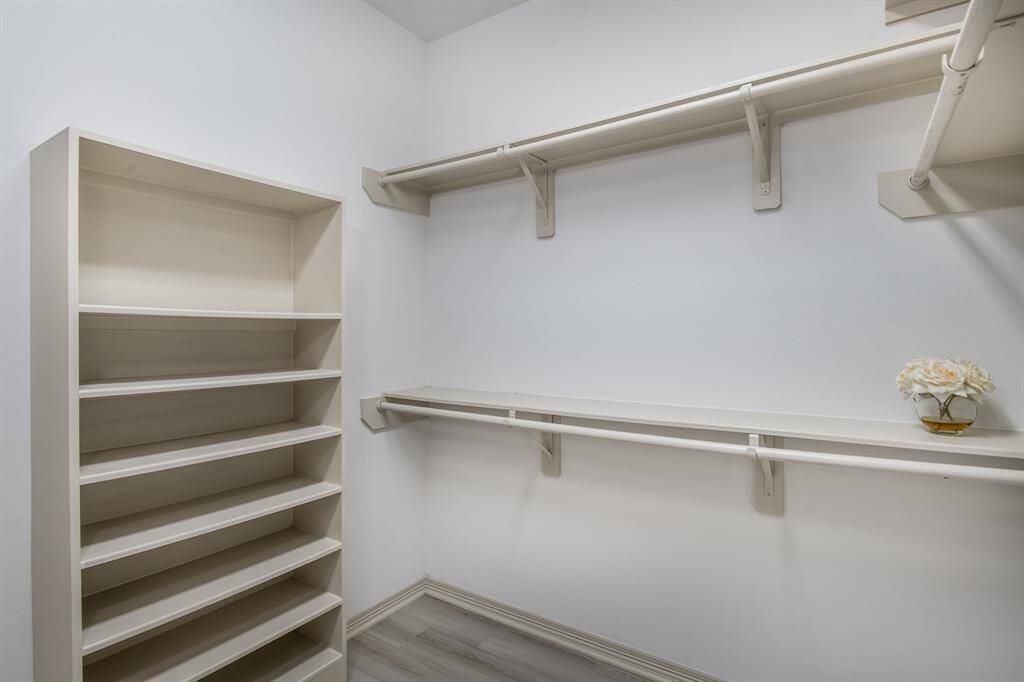 The primary closet offers generous storage with built-in shelves and hanging space, keeping your wardrobe organized and easily accessible.