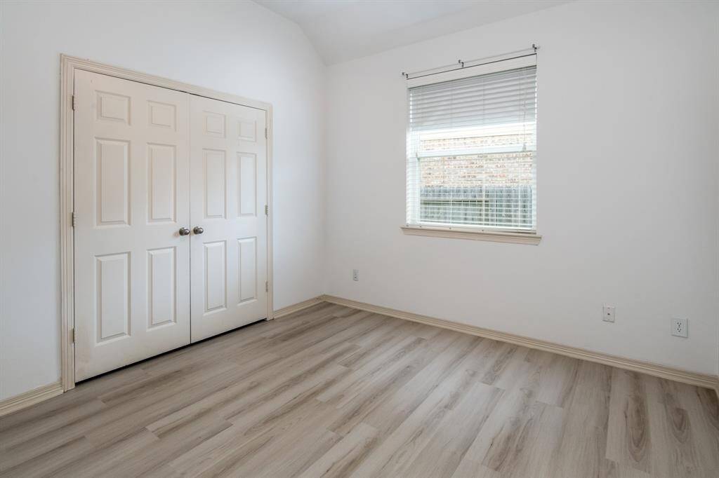 This smaller fourth bedroom is perfect for a child's room, guest space, or home office, featuring natural light and a comfortable, versatile layout.