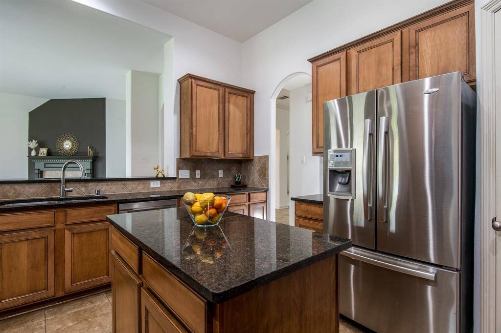 Spacious and functional, this kitchen boasts abundant cabinet storage, a center island, and a layout perfect for cooking and entertaining