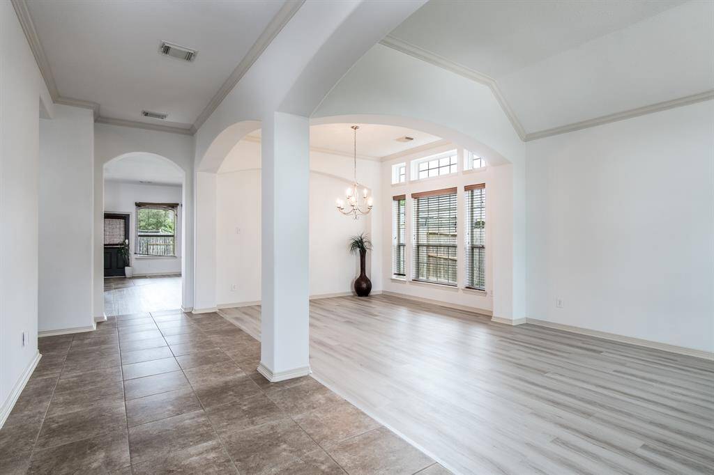 Elegant and inviting, the formal living and dining rooms offer a refined space for entertaining. With large windows, and a seamless flow between the two areas, these rooms combine classic charm with a comfortable atmosphere.