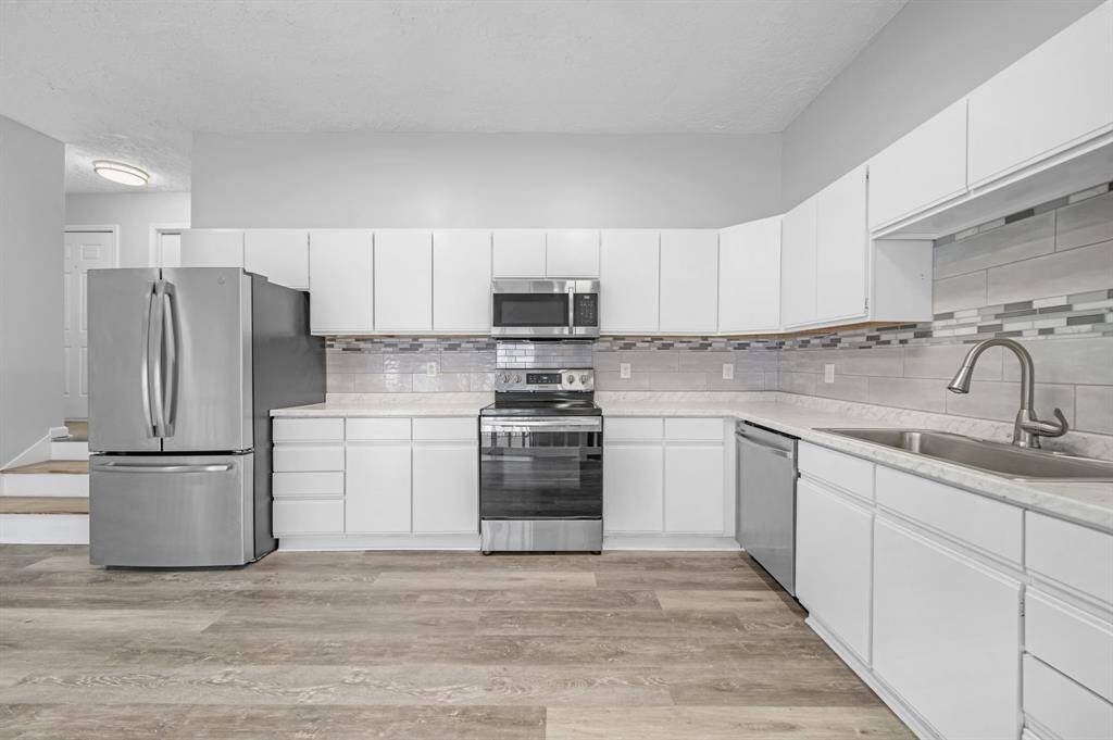 Single basin sink with stainless steel appliances.
