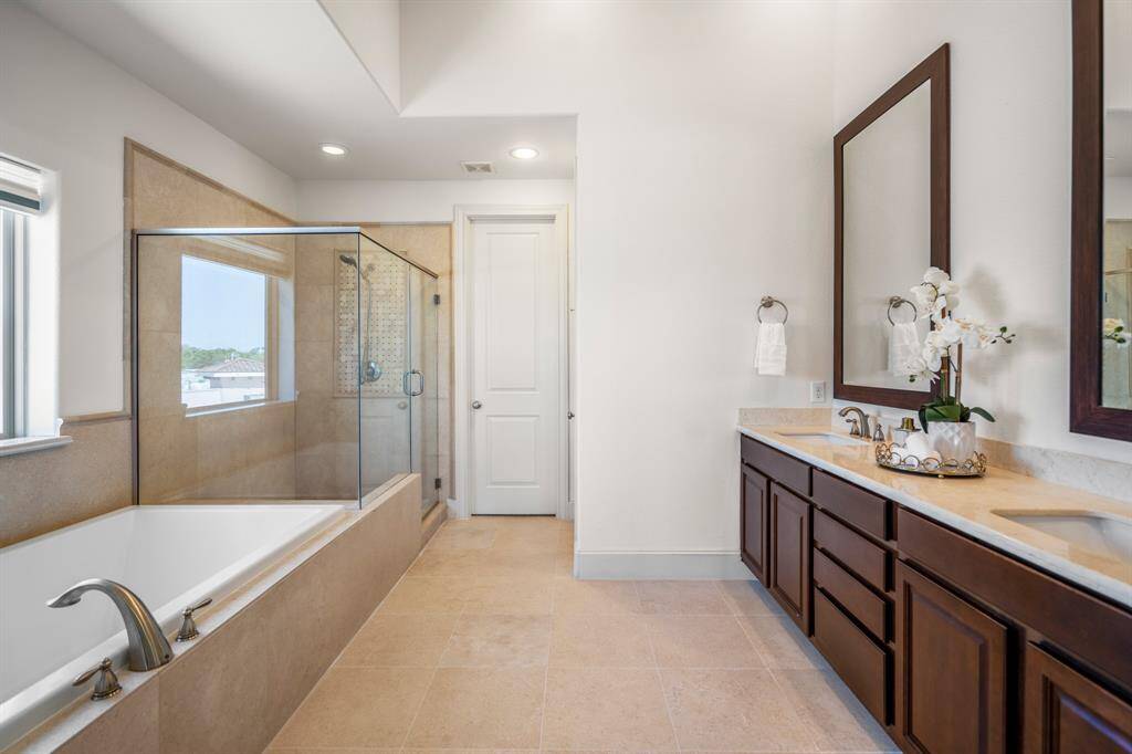 Relax and unwind in the spa-like primary bath with a 6-ft garden tub and separate glass shower.
