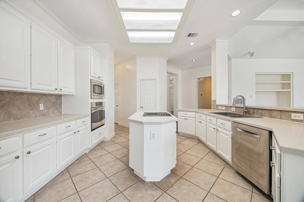 Due to the light colored selections used in the home from the cabinets to the flooring, this North/South facing home never seems dark!