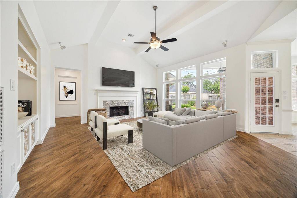 The light & bright Living Room overlooks the covered patio. This room can accommodate many different furniture configurations! Virtually staged!