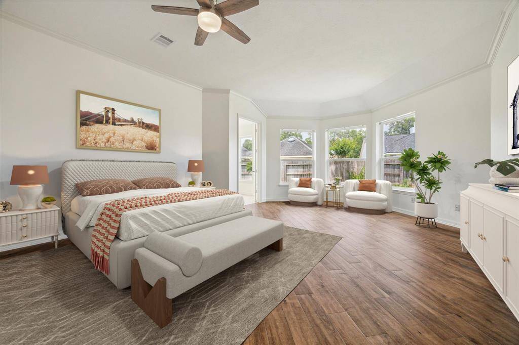 The spacious Primary Suite features three large bay windows bringing in plenty of natural light and continued wood tile. Virtually staged.