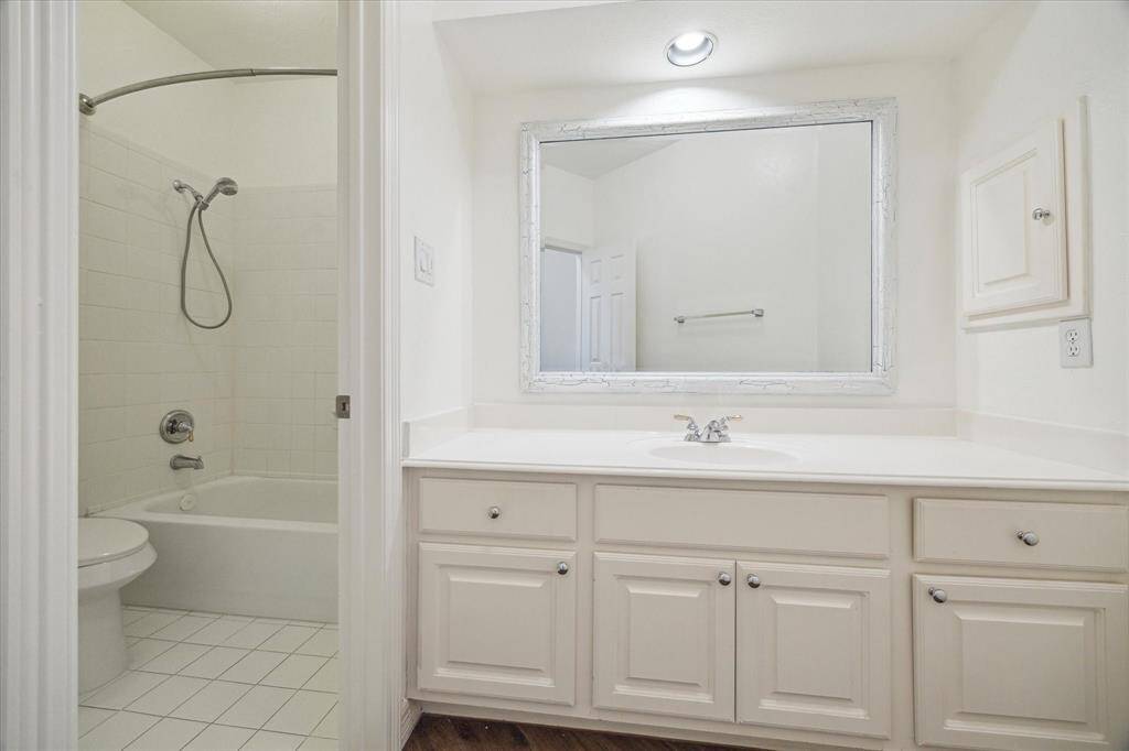 Guest bathroom features a tub.
