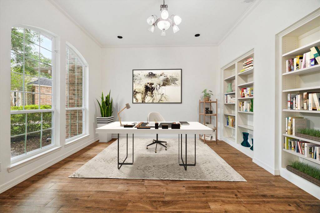 The Study with built in's overlooks the front yard & has a wall of windows that flood the room with plenty of natural light! Virtually staged.