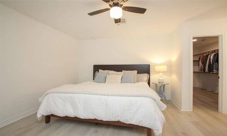 Primary Bedroom with Ensuite AccessSpacious primary suite with ceiling fan and access to private bath and closet.