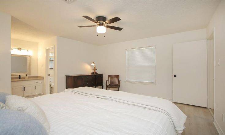 Primary Bedroom with EnsuiteSpacious primary retreat with ceiling fan and private bath access.